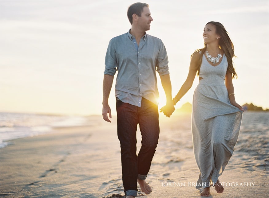 cape may engagement photos couple walking on beach