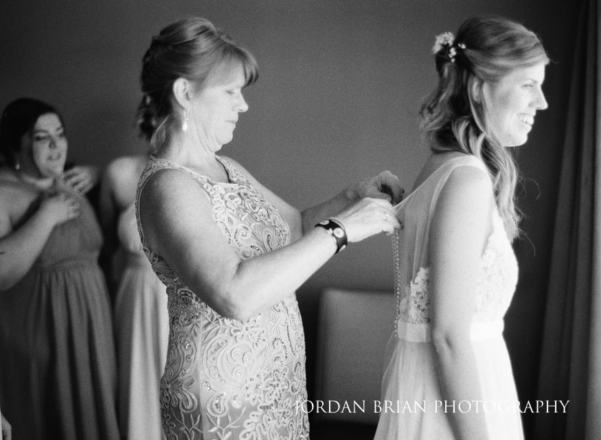 Bride getting ready in her Watters & Watters wedding dress.