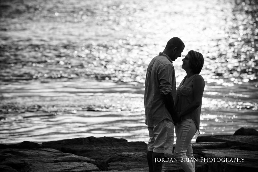 couple by the water at long beach island engagement session