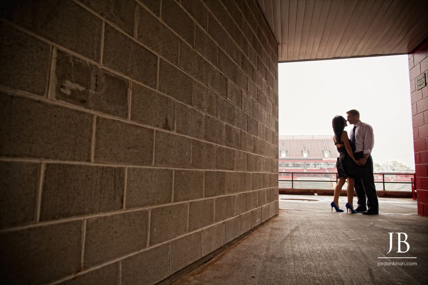 Rutgers university engagement session couple together in football stadium tunnel