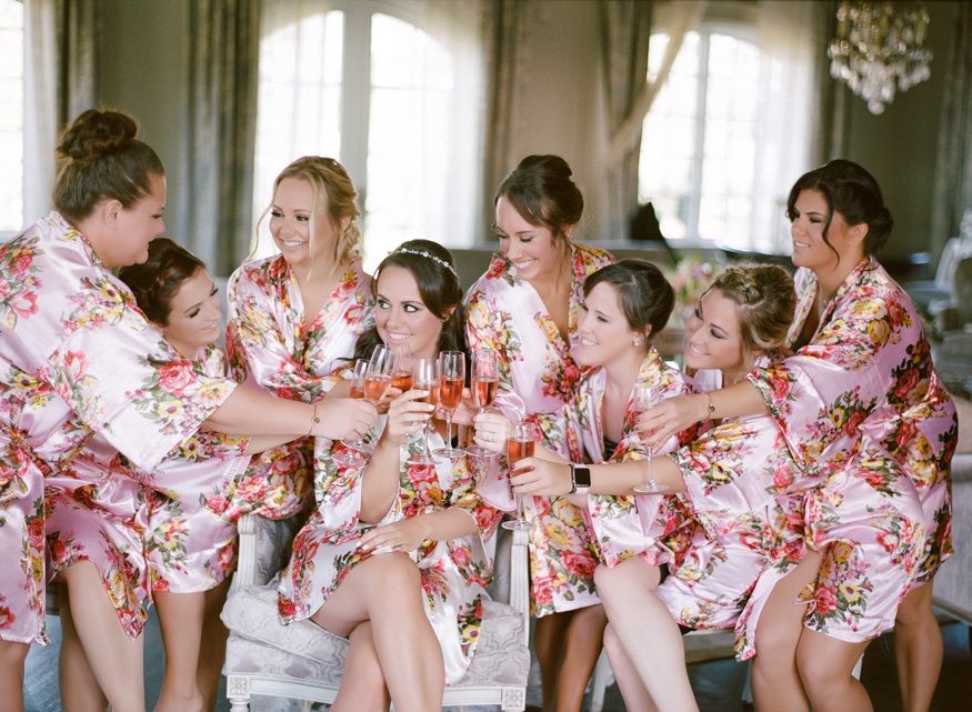 Bride and bridesmaids in matching robes at Park Chateau wedding.