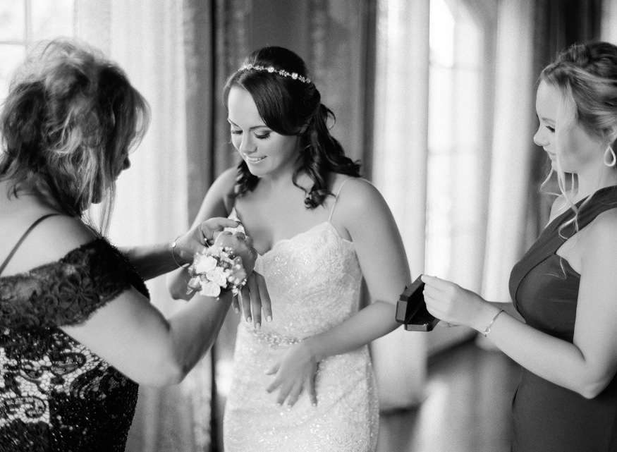 Bride getting dress in Anne Barge wedding dress at the Park Chateau.