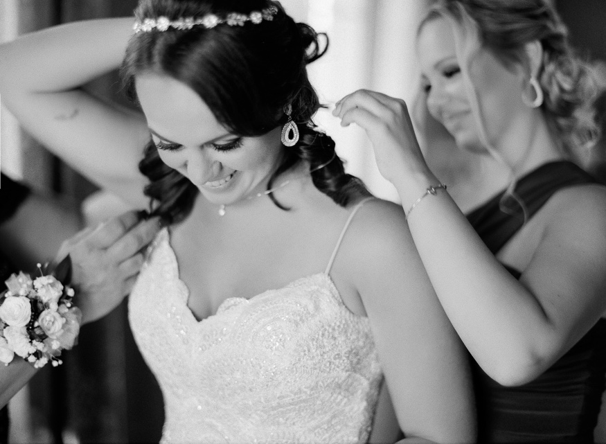 Bride getting dress in Anne Barge wedding dress at the Park Chateau.