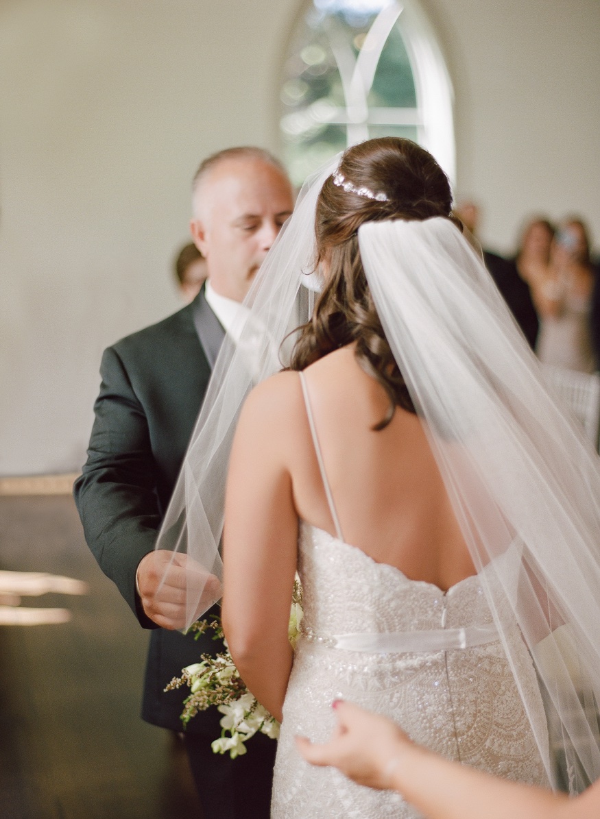 Bride and father walk down the aisle at the Park Chateau wedding ceremony.