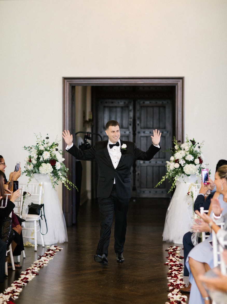Groom walking down aisle at ceremony at the Park Chateau.