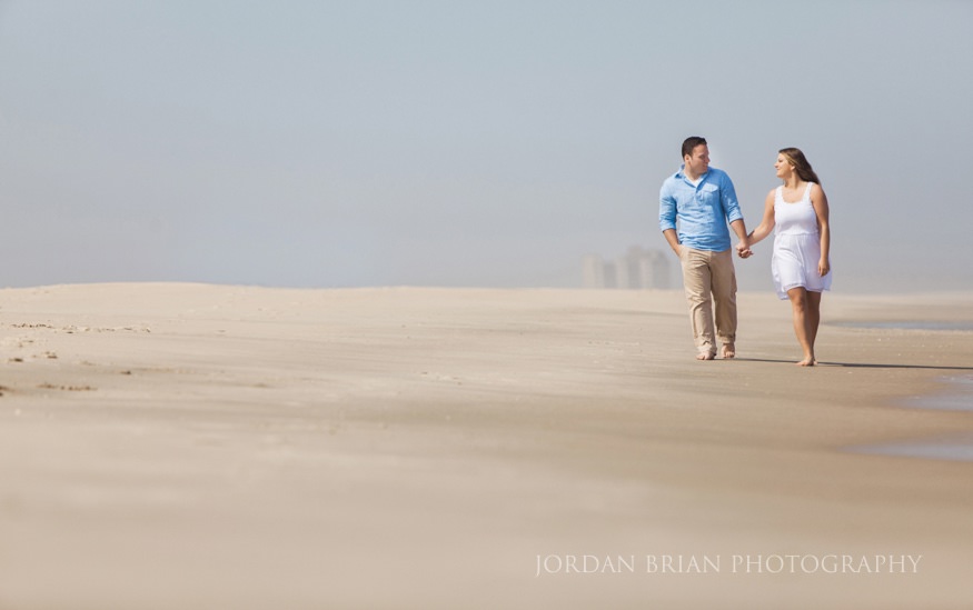 couple walking on the beach at long branch beach engagement