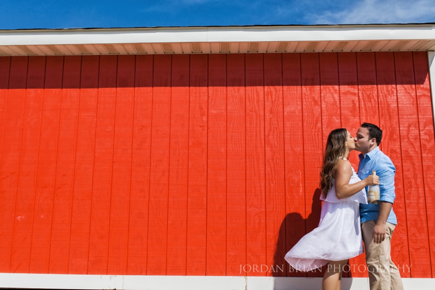 couple infront of life guard stand on beach at long branch beach engagement session