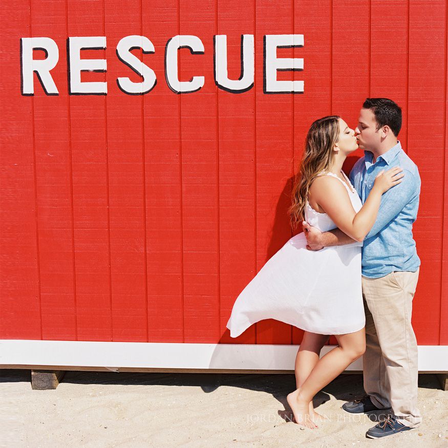 couple in front of life guard stand at long branch beach engagement session