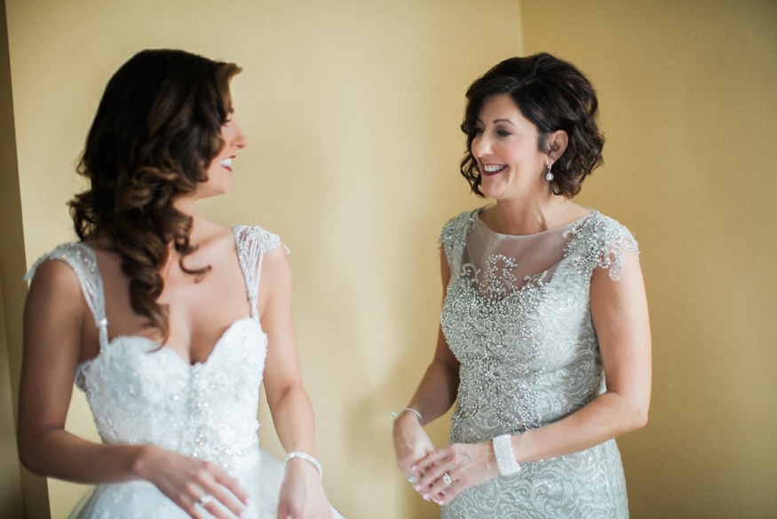 Bride getting ready with her mom in the morning before her wedding.