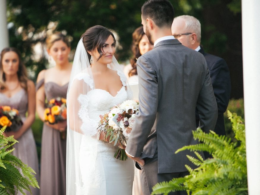 Bride and Groom at outdoor wedding ceremony at Knowlton Mansion.