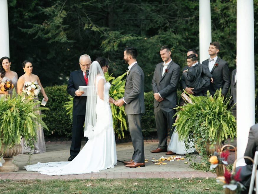 Bride and Groom at outdoor wedding ceremony at Knowlton Mansion.
