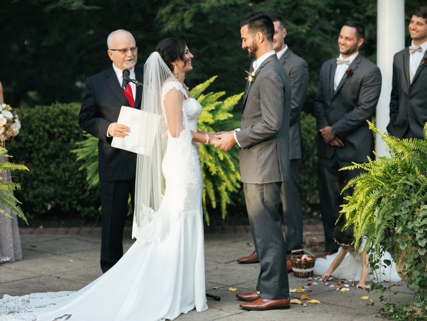 Bride and Groom at outdoor wedding ceremony at Knowlton Mansion.