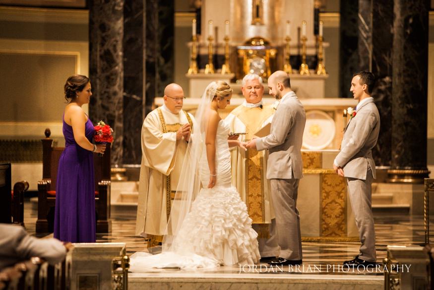 Bride and groom exchange rings at St Peter Cathedral.
