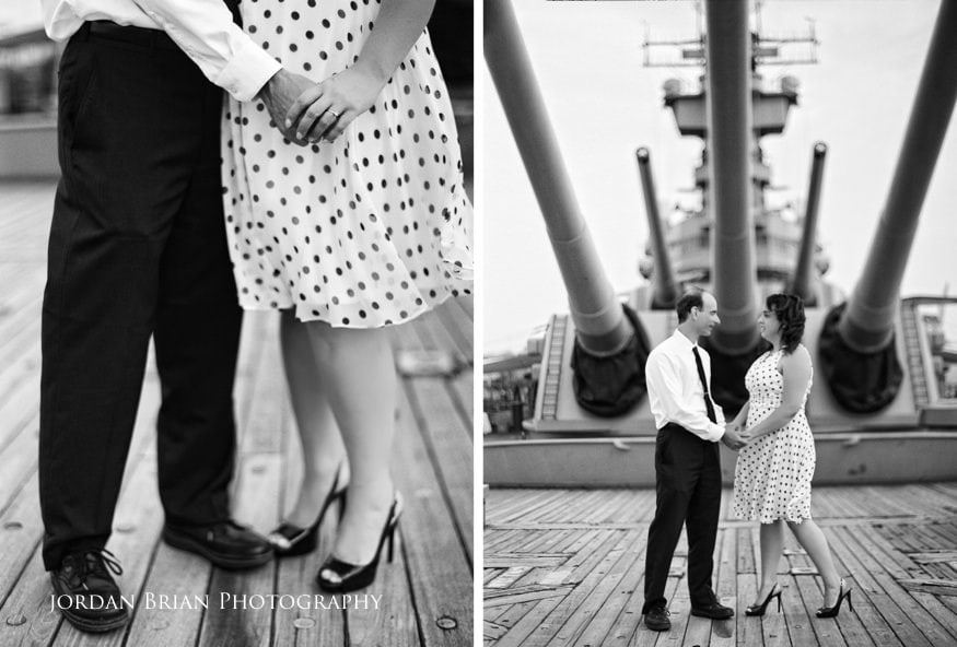 Denise and Tom posing along the rail of the Battleship New Jersey with the Delaware River behind them