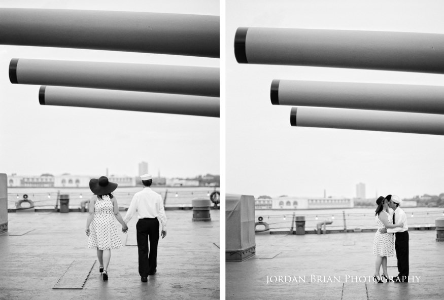 Denise and Tom embracing on the deck of the Battleship New Jersey on a summer evening