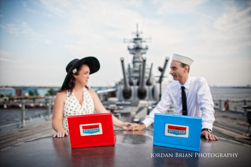 Denise and Tom laughing together on the Camden waterfront aboard the USS New Jersey