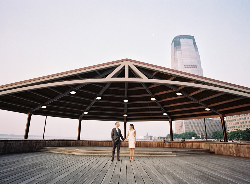 Thomas whispering to Elina during their sunrise engagement session in Jersey City.