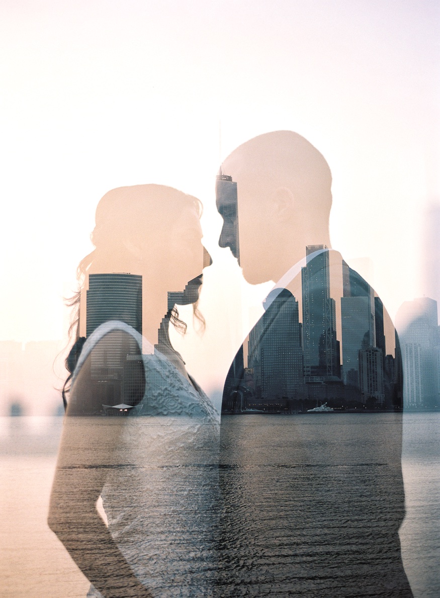 Thomas and Elina silhouetted against the early morning sky over the Hudson River.