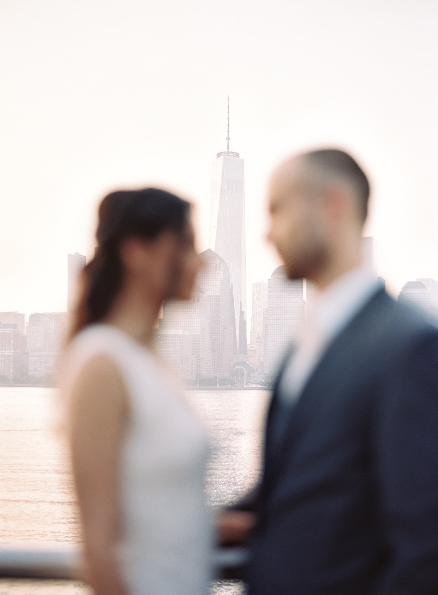 Portrait of Thomas and Elina in warm morning light with the Manhattan skyline.