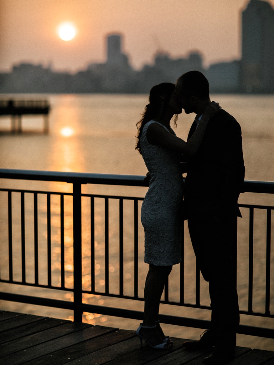 Thomas dipping Elina along the Jersey City waterfront as the sun rises over New York City.