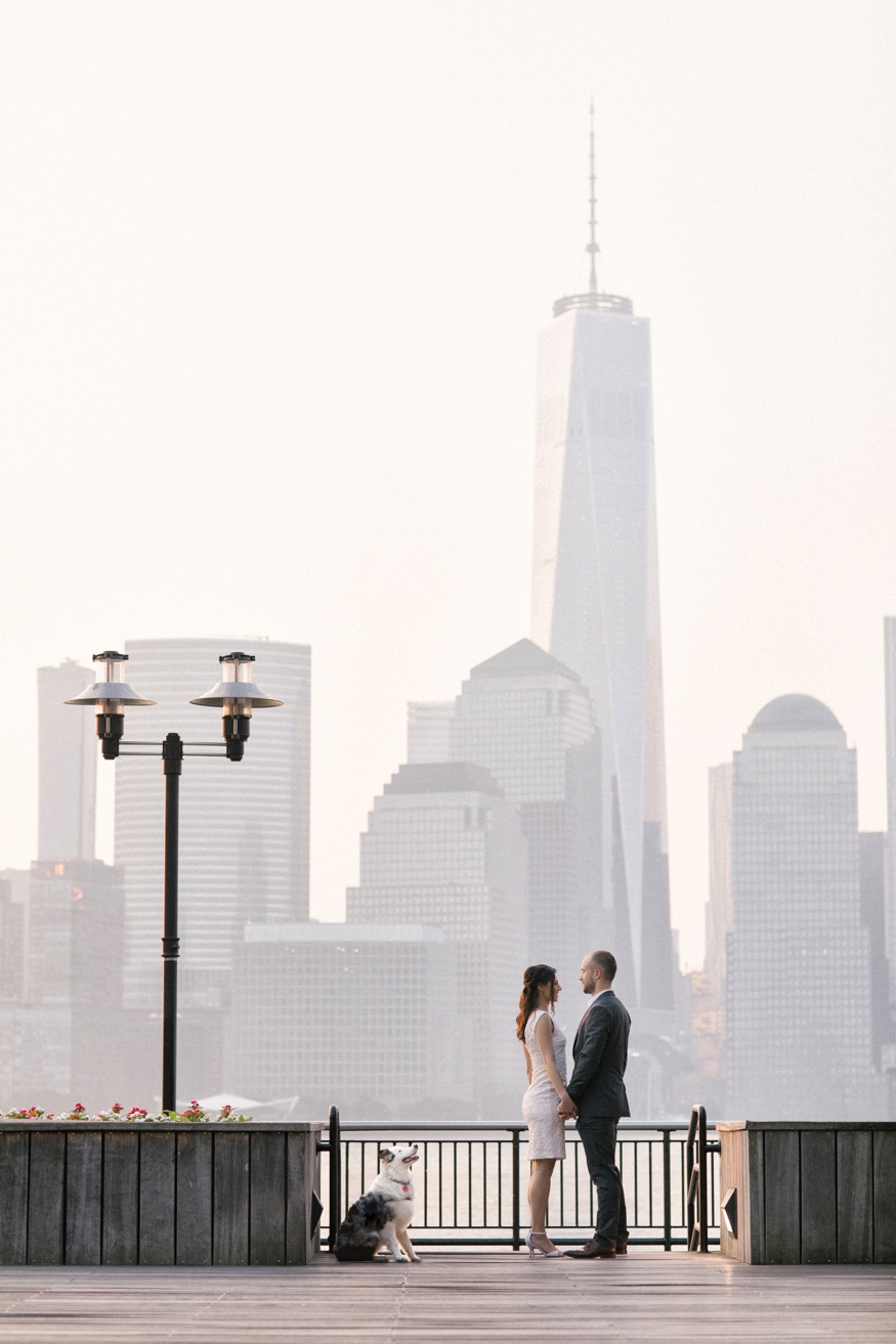 Thomas and Elina, full-length portrait at sunrise on the Jersey City waterfront.
