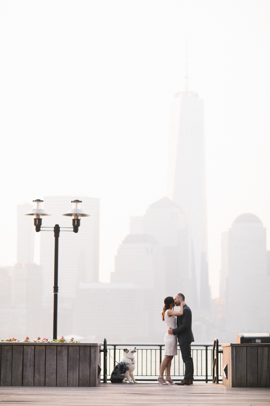 Elina and Thomas walking toward the camera, NYC skyline glowing golden at dawn.