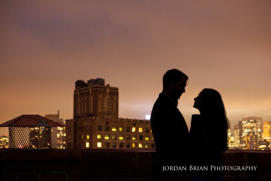 silhouette of couple with new york city skyline at engagement session