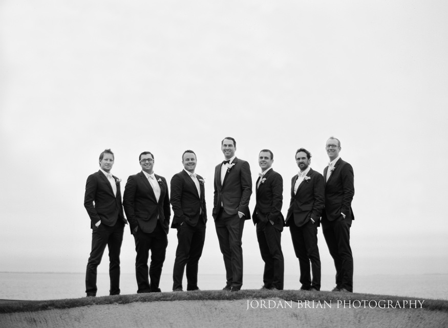 portrait of groomsmen on golf course at rehoboth beach country club wedding
