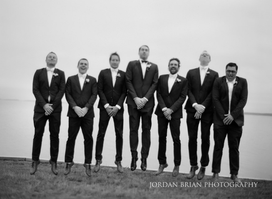 groomsmen jumping on golf course at rehoboth beach wedding