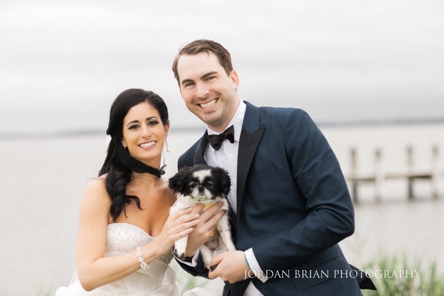 portrait of couple with their dog at wedding