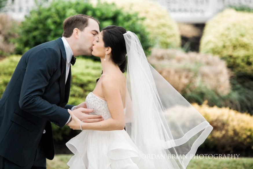bride and groom kiss at rehoboth beach country club wedding