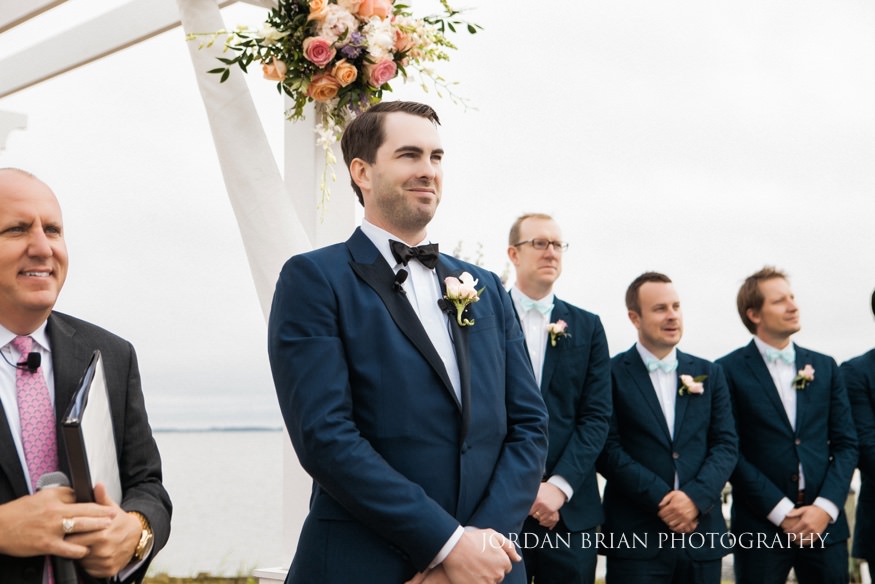 groom seeing bride at outdoor wedding ceremony