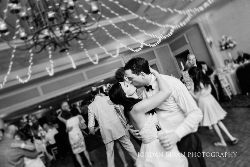 bride and groom kiss at rehoboth beach country club wedding