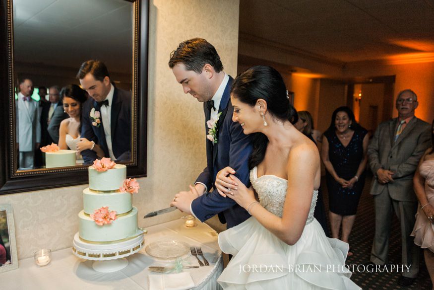 bride and groom cut cake at rehoboth beach country club wedding