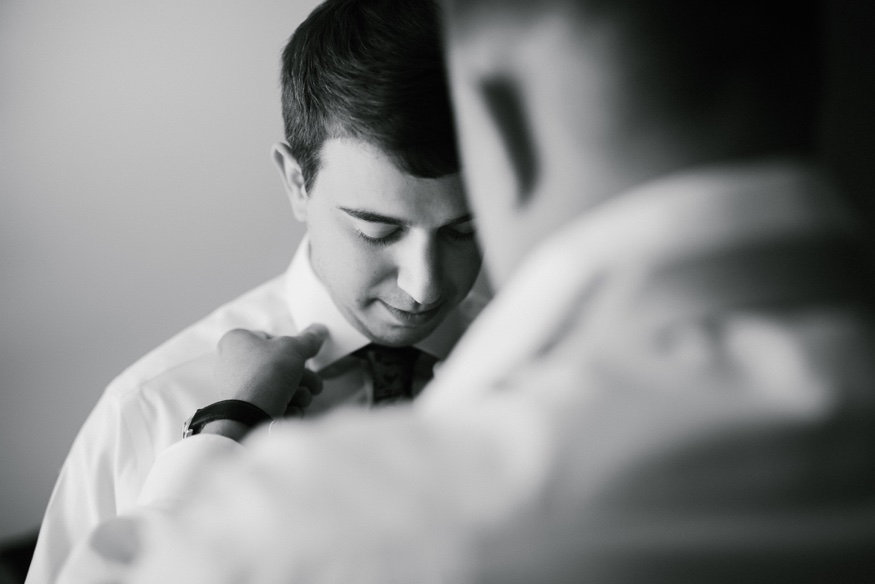 Groom's portraits at Courtyard Marriott before Pen Ryn wedding.