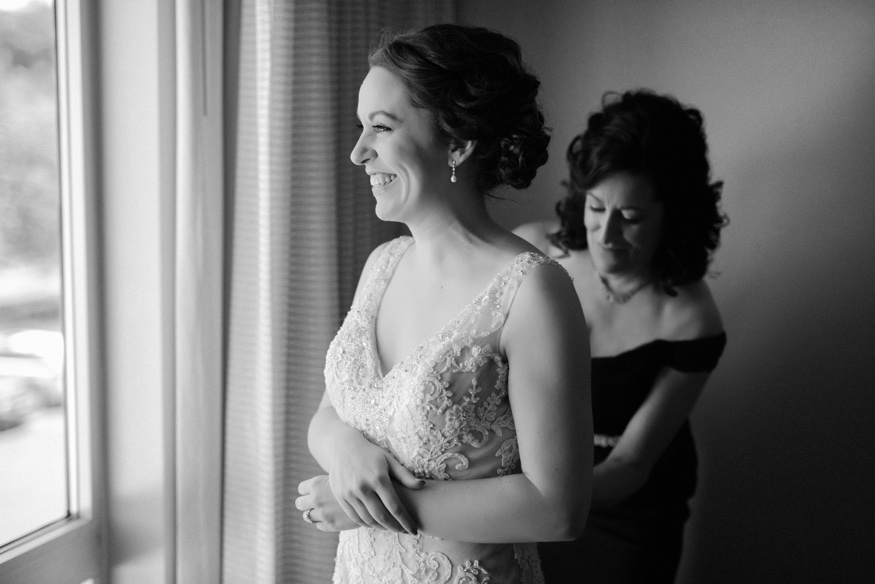 Bride getting ready in Demetrios wedding dress before Pen Ryn wedding.