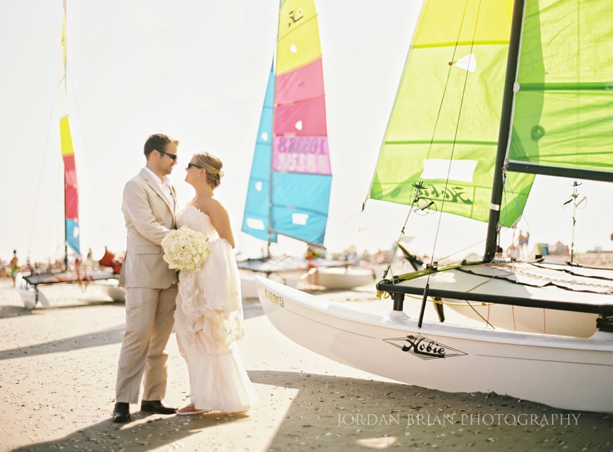 couple by sailboats at ocean city wedding