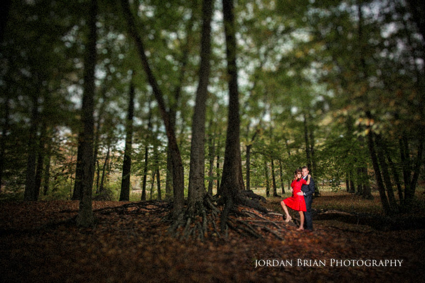 Holly and Chris holding hands among fall leaves at Medford Park