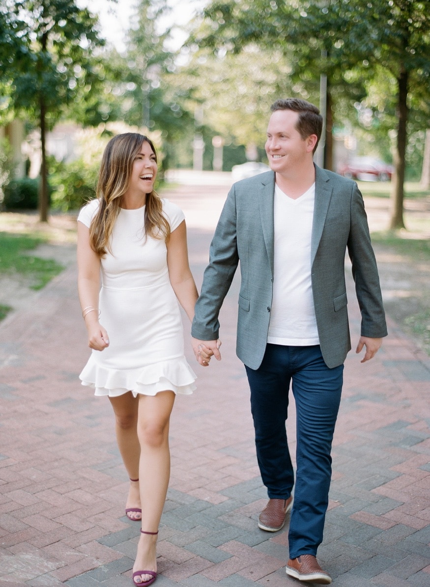 Vertical portrait of Jamie and Chad at Franklin Square, Old City Philadelphia backdrop.