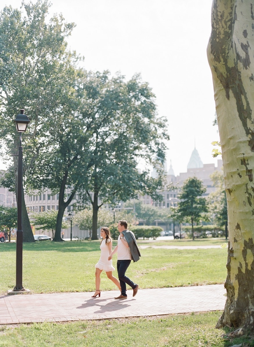 Vertical portrait of Jamie and Chad near the Ben Franklin Bridge side of Franklin Square.