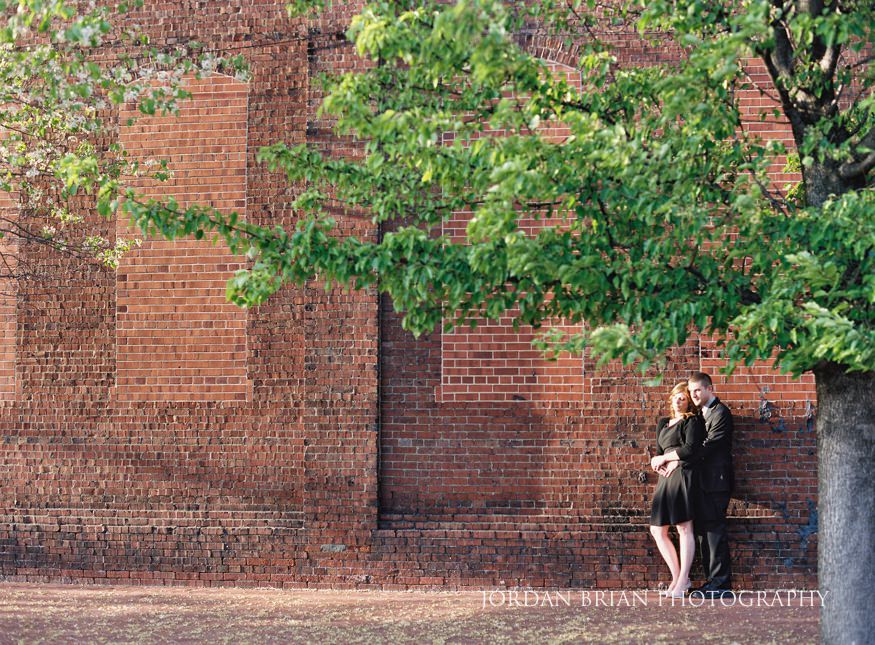 portrait of couple against brick wall
