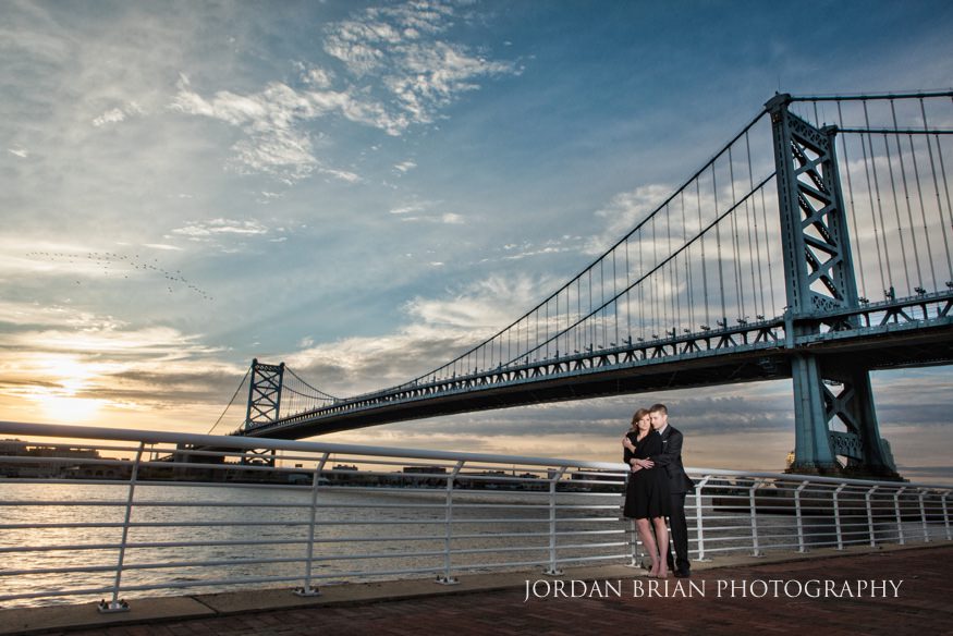 couple in front of ben franklin bridge camden waterfront
