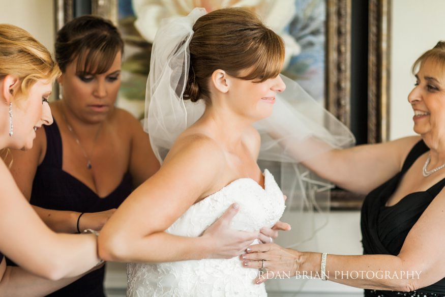 Bride putting wedding dress on at Trump National