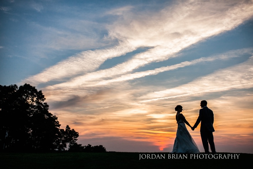 Bride and groom in front of sunset at Trump National Philadelphia wedding.