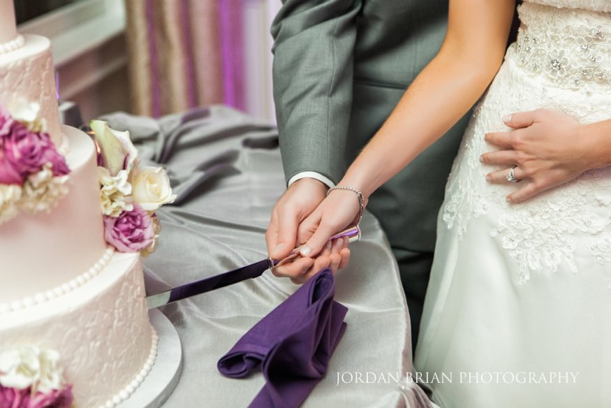 Bride and groom cut cake at Trump National wedding.
