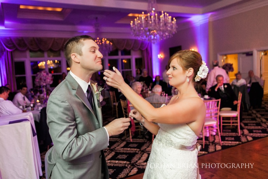 Bride and groom cut cake at Trump National wedding.
