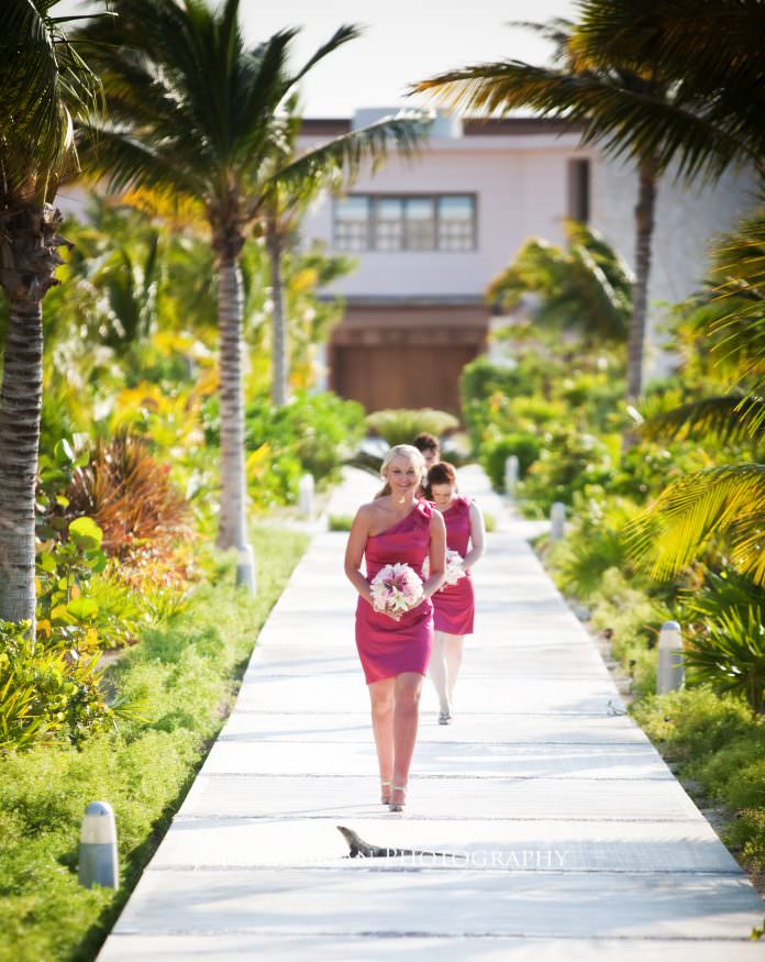 Bridal party walking past iguanas on resort grounds at Excellence Resort Mexico