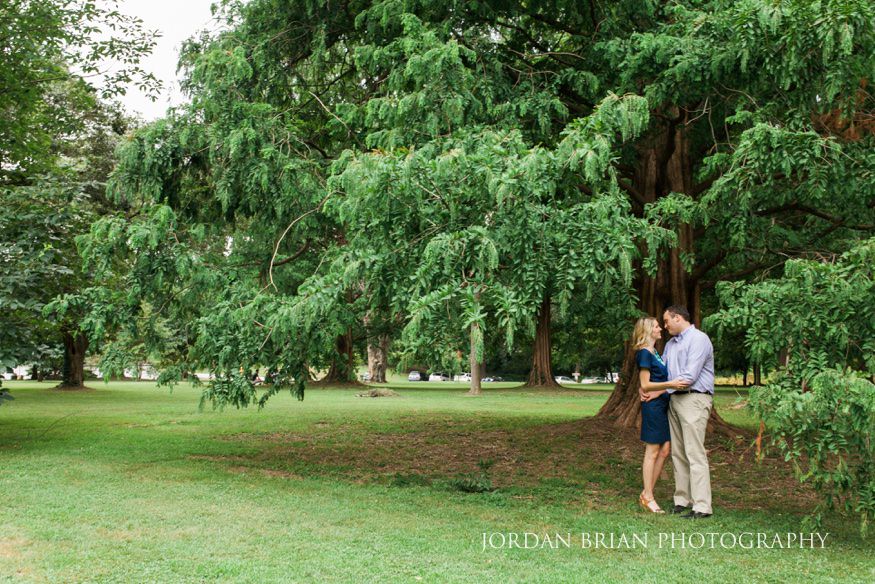 Katarina and Kyle joining strangers for a wine picnic during their Fairmount Park engagement session