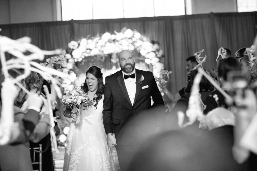 Bride and groom exiting wedding ceremony at Moulin Philadelphia.