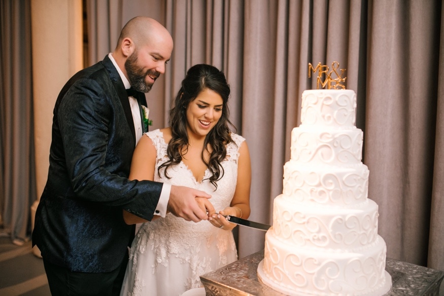 Bride and groom cut the cake from Isgro Bakery at Moulin Philadelphia wedding reception.